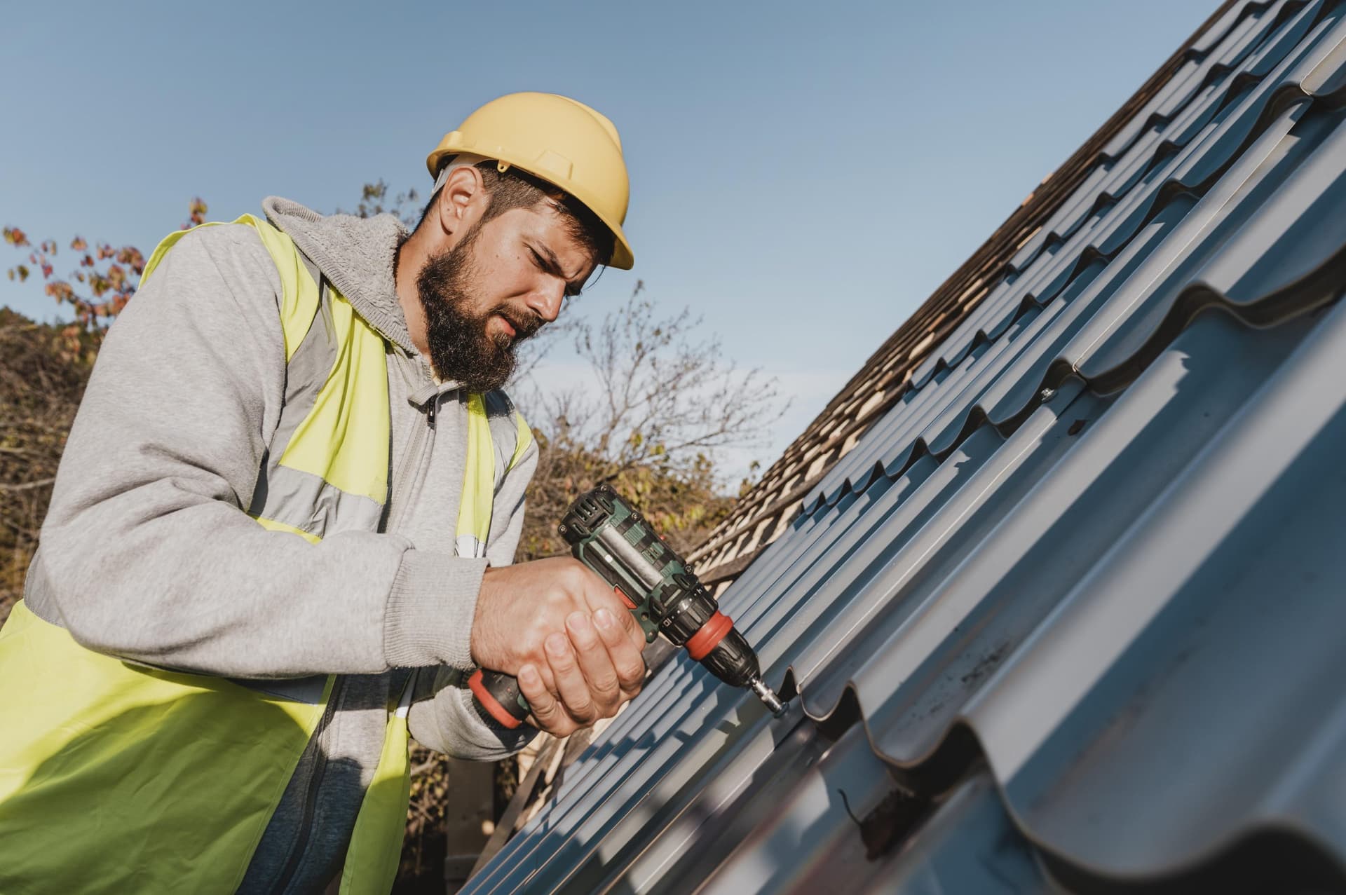 B.K. Roofing technician repairing a roof leak
