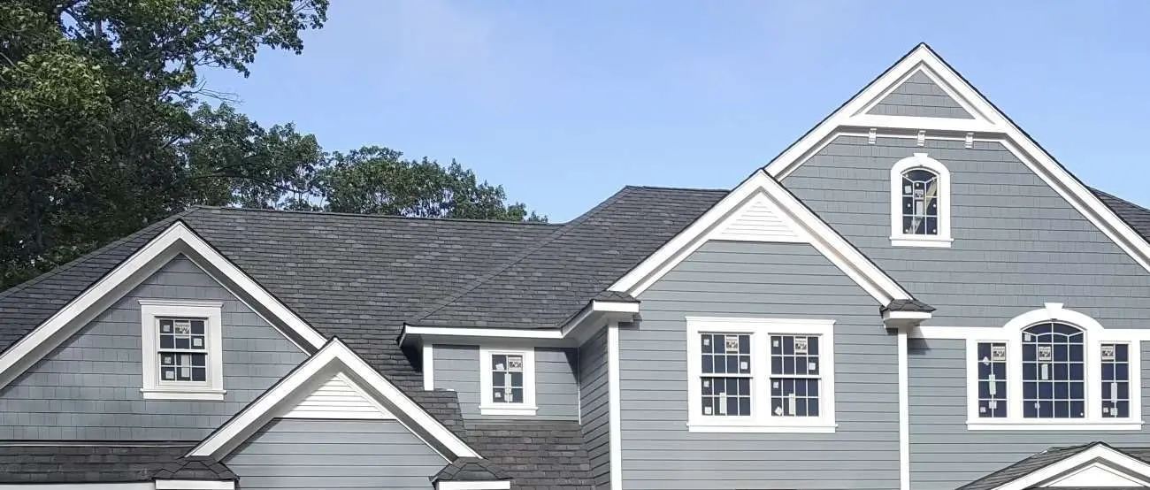 A completed gray-roof home used as a general exterior-color reference. It is not labeled as a specific GAF Designer Shingle product.